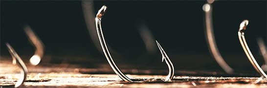 Barbed fly hooks